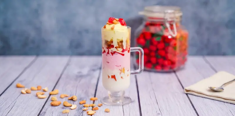 Gadbad — layered ice cream with jelly, nuts, and fresh fruit